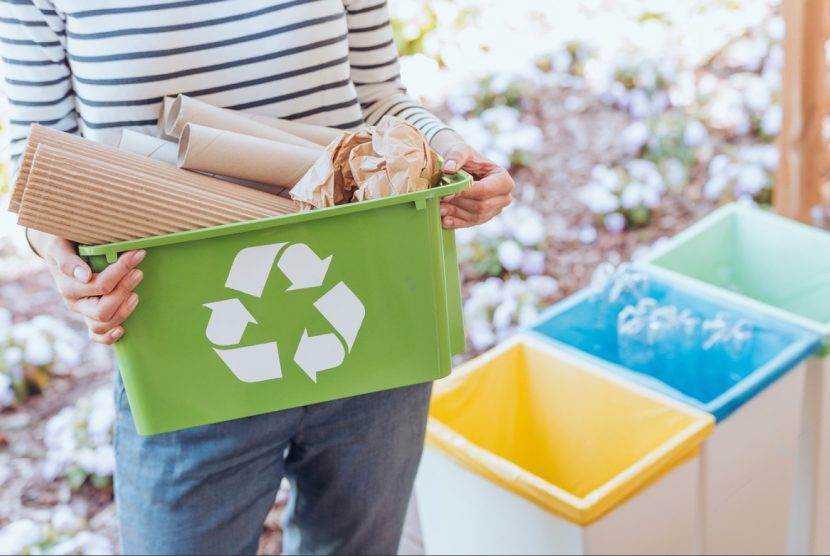 stock-photo-activist-taking-care-of-environment-sorting-paper-waste-to-proper-recycling-bin-on-terrace-709345111-transformed