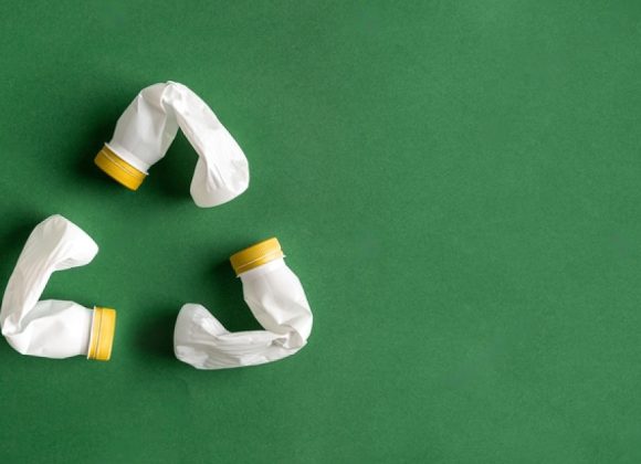 stock-photo-white-recycle-sign-created-of-plastic-bottles-on-green-background-flat-lay-with-copy-space-pet-1788453752-M9KdhjwLp-transformed