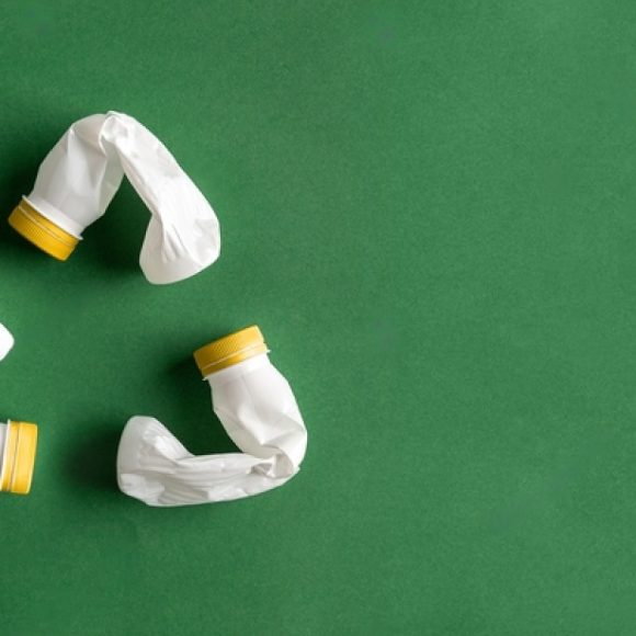 stock-photo-white-recycle-sign-created-of-plastic-bottles-on-green-background-flat-lay-with-copy-space-pet-1788453752-M9KdhjwLp-transformed